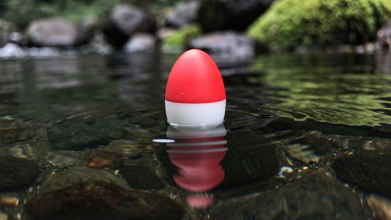 Fishing float in the clear waters of a mountain river, photographed in close-up.