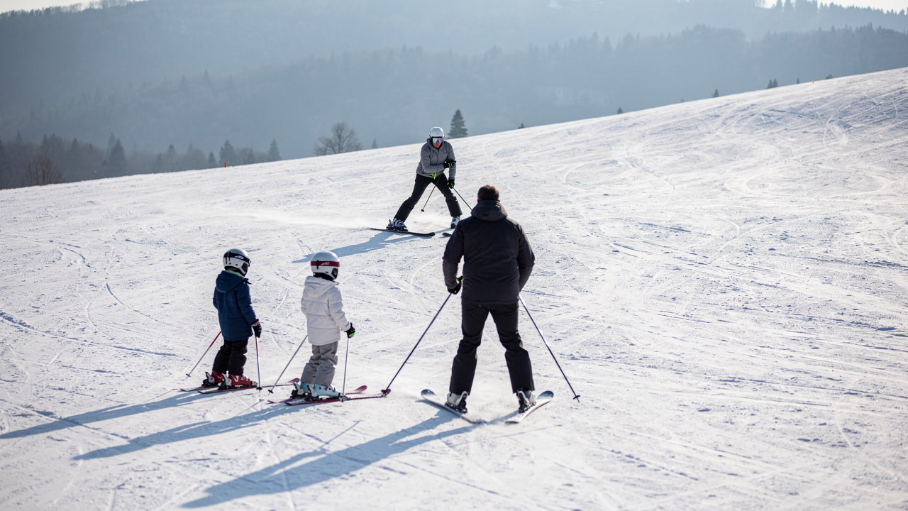 A family with children taking a ski lesson on a gentle slope on Vitosha.